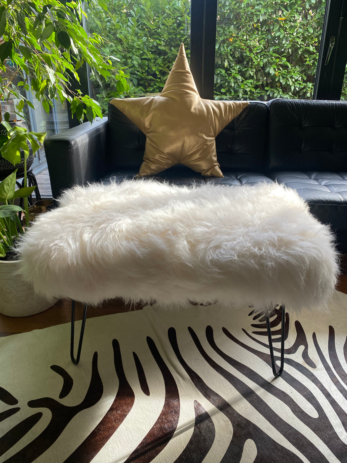 sheepskin upholstered footstool with hairpin legs