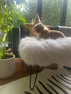sheepskin upholstered footstool with hairpin legs