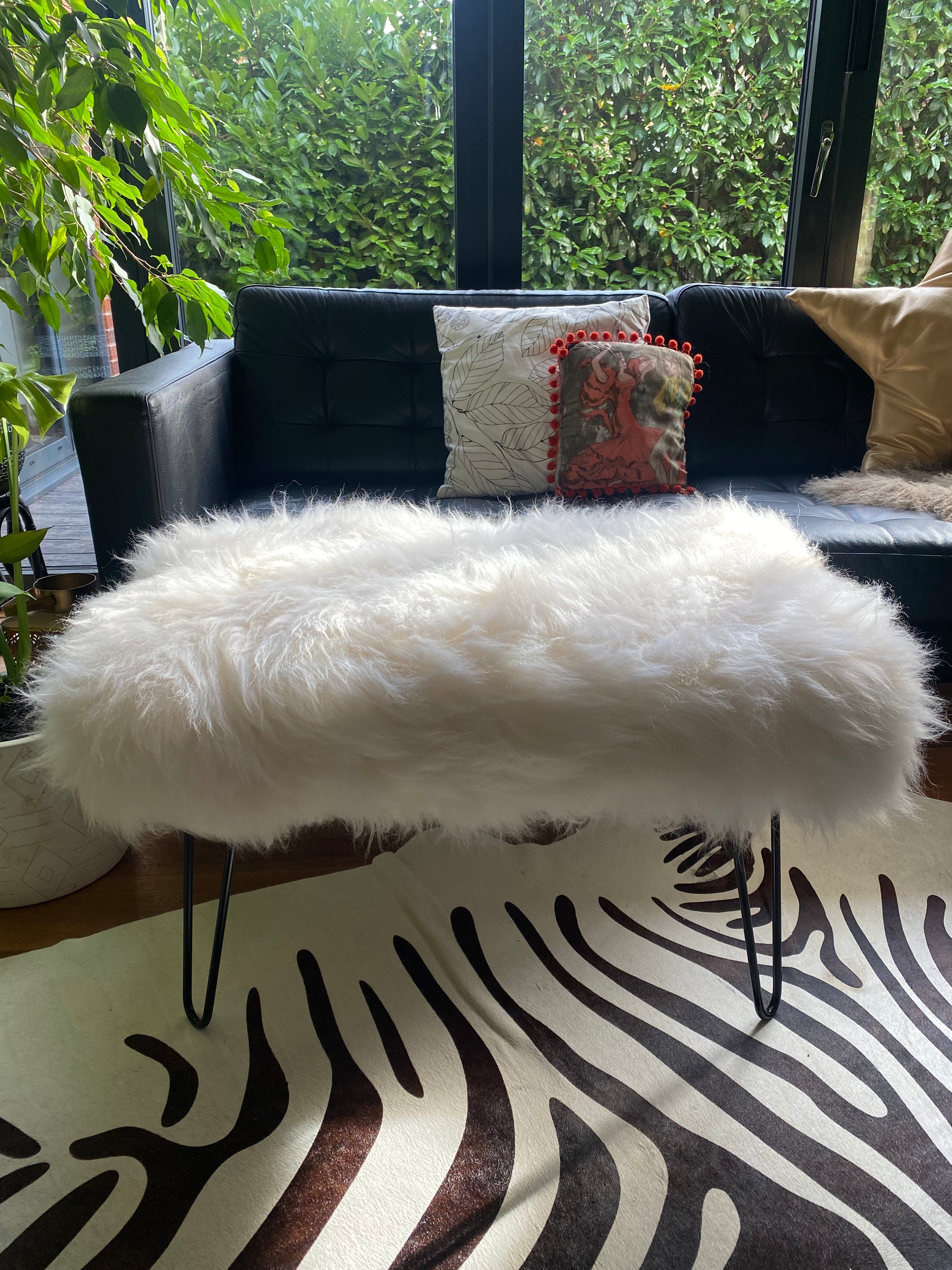 sheepskin upholstered footstool with hairpin legs