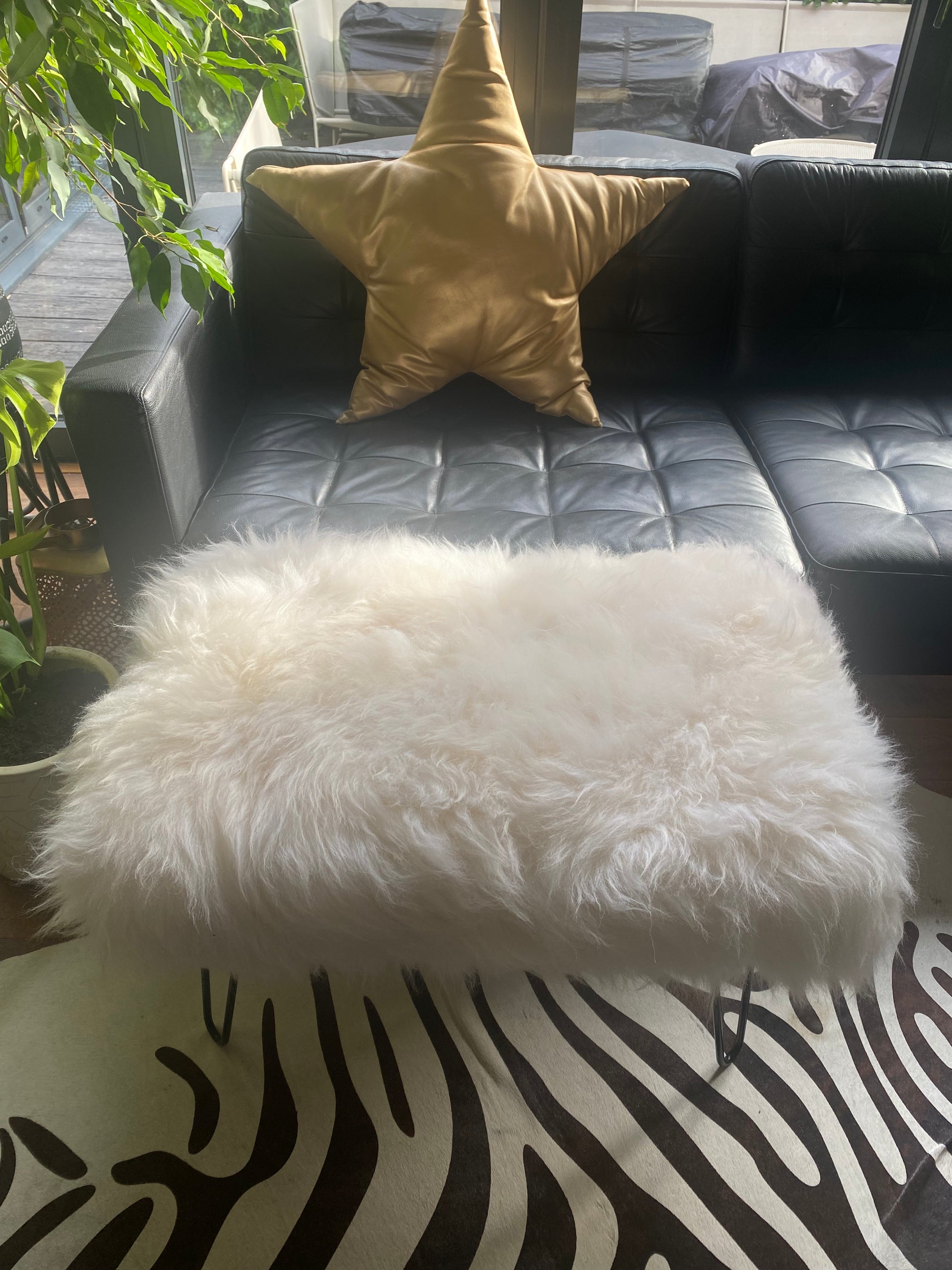 sheepskin upholstered footstool with hairpin legs