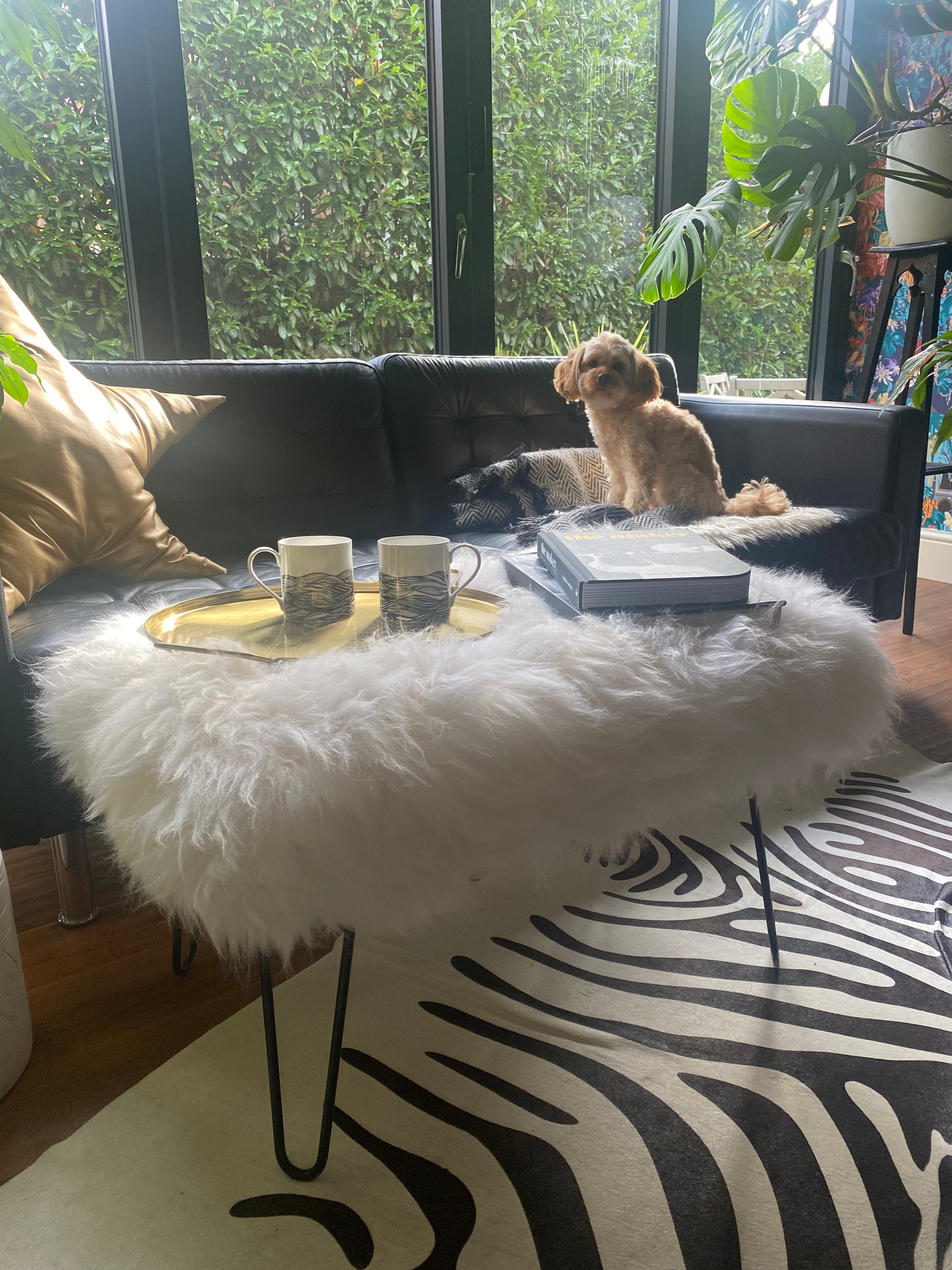 sheepskin upholstered footstool with hairpin legs