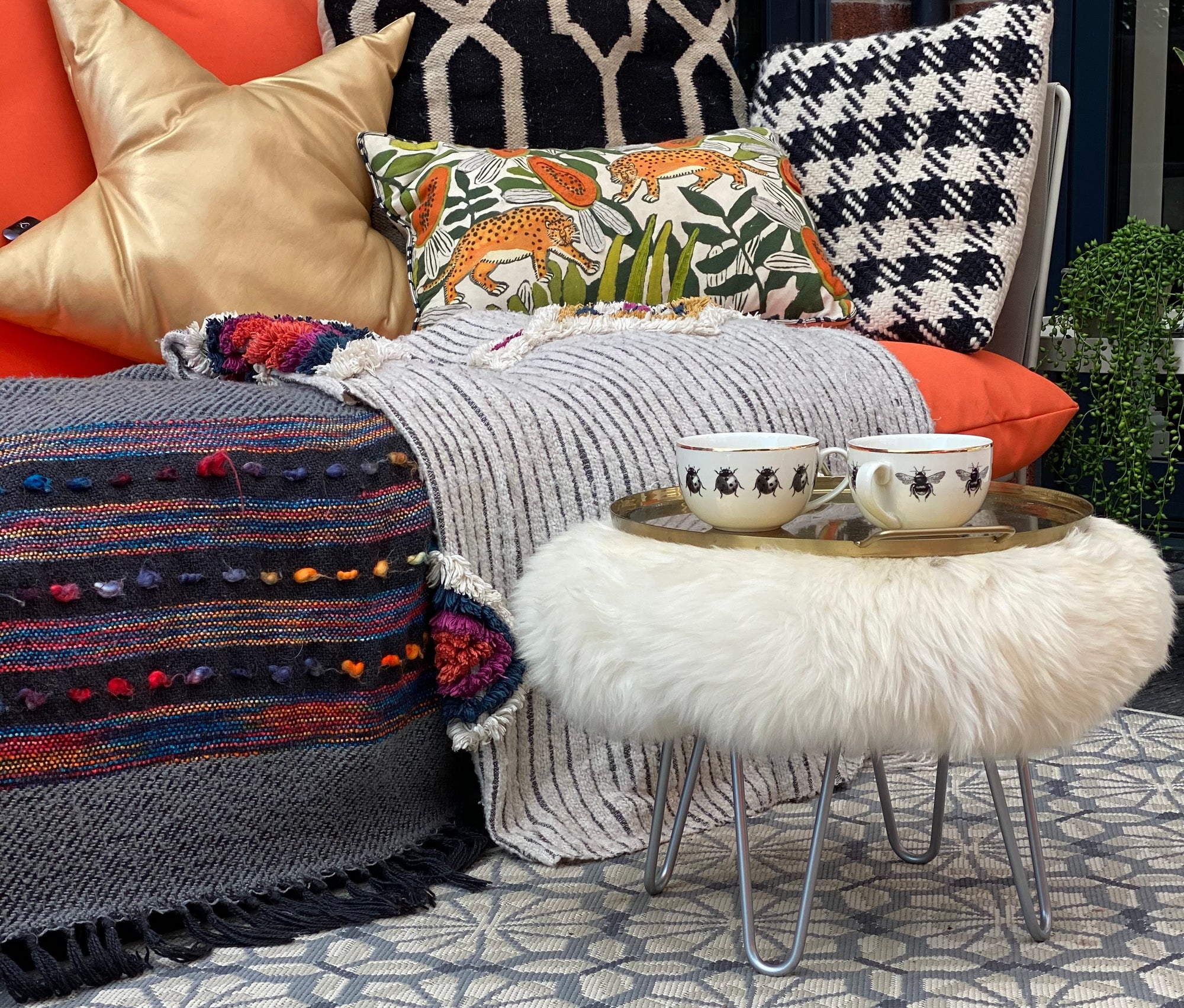 round sheepskin footstool pouffe hairpin leg  Edit alt text