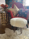 small round sheepskin pouffe footstool with hairpin legs
