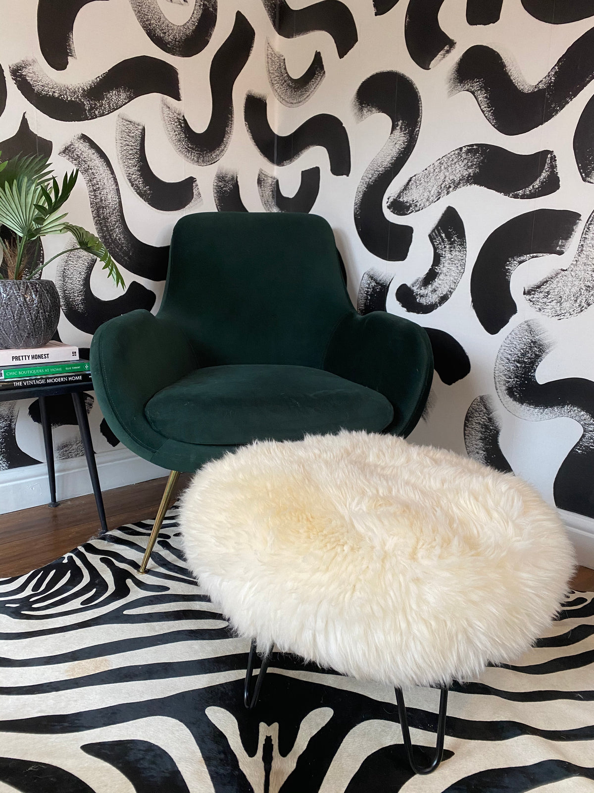 small round sheepskin pouffe footstool with hairpin legs